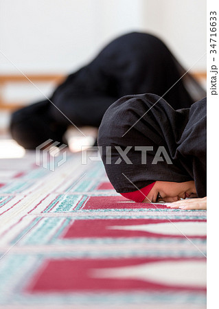 Two Muslim women praying Two Muslim women praying 34716633