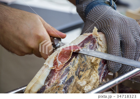 Slicing dry-cured ham prosciutto  34718323