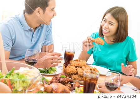 Happy Asian couple having dinner Happy Asian couple having dinner 34724304