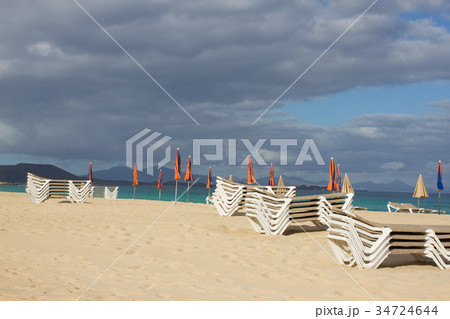 Many beach umbrella and chair on horizon line Many beach umbrella and chair on horizon line 34724644