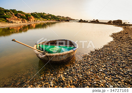 A basket boat at Co Thach beach in early morning A basket boat at Co Thach beach in early morning 34727103