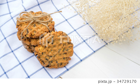 chocolate chip cookies on a white wooden table. 34729170