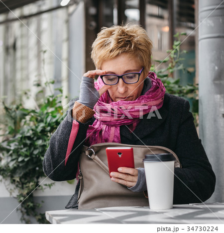 Adult woman surfing phone 34730224