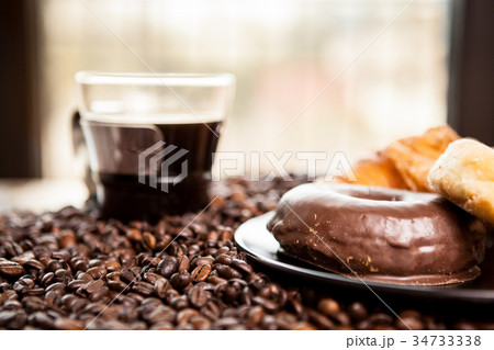 Coffee beans, donut and a cup of coffee 34733338