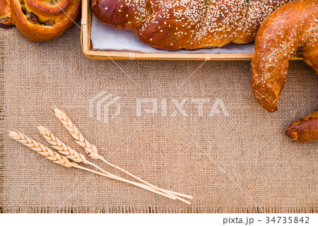Bakery products lying on a tablecloth 34735842