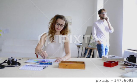 Beautiful designer enjoying her work on a project. Beautiful designer enjoying her work on a project. 34736092