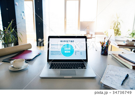 Office desk with laptop, coffee cup and office 34736749