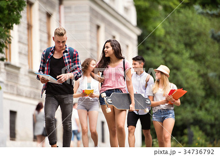 Group of attractive teenage students walking to Group of attractive teenage students walking to 34736792