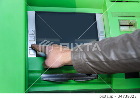 A man's hand is pushing the button. 34739328