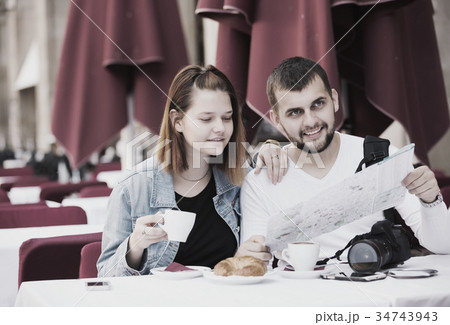man and woman looking at map man and woman looking at map 34743943
