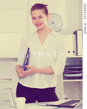 Businesswoman is standing with documents 34743949