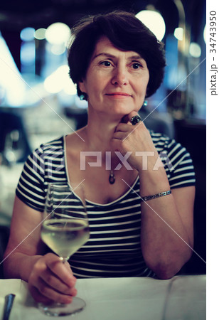 Elderly lonely woman at dinner in restaurant 34743950