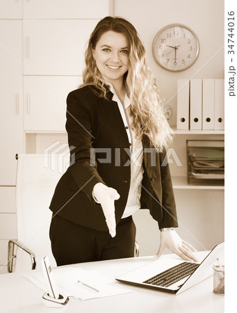 Cheerful businesswoman in suit working 34744016