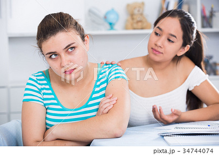 Girl trying to apologize to friend Girl trying to apologize to friend 34744074