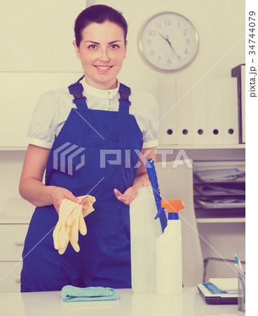 Young and smiling woman cleaning room 34744079