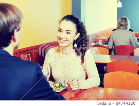 Couple having dinner at restaurant table 34744220