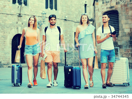 People taking promenade with suitcases People taking promenade with suitcases 34744345
