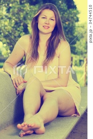 Cheerful female is resting on the bench 34744510