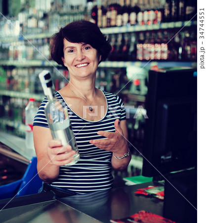 Ederly woman cashier at store 34744551