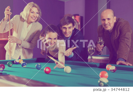 People playing billiard 34744812
