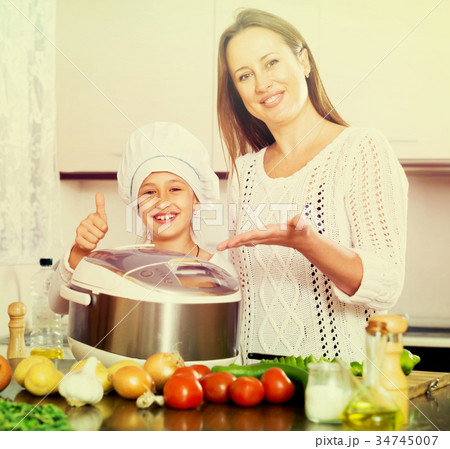 mother and daughter using multicooker mother and daughter using multicooker 34745007