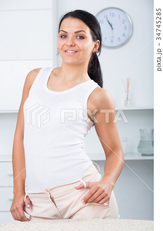 Young brunette woman in white 34745285