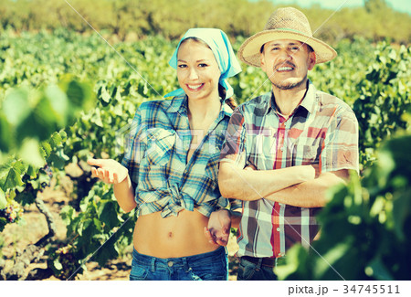 Gardeners together in grapes tree yard Gardeners together in grapes tree yard 34745511