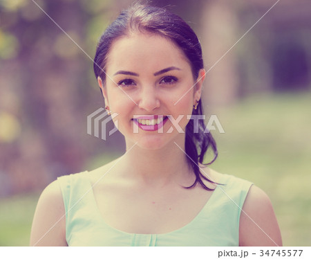 cheerful smiling young woman portrait in outdoors 34745577