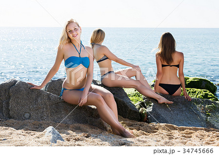 Girl in bikini taking sunbath Girl in bikini taking sunbath 34745666