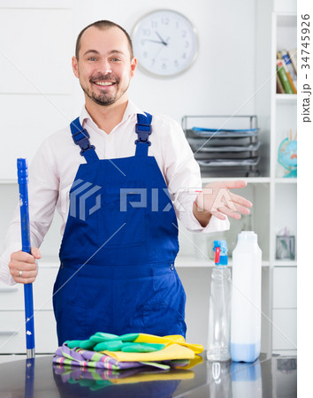 Young man in apron cleaning table Young man in apron cleaning table 34745926