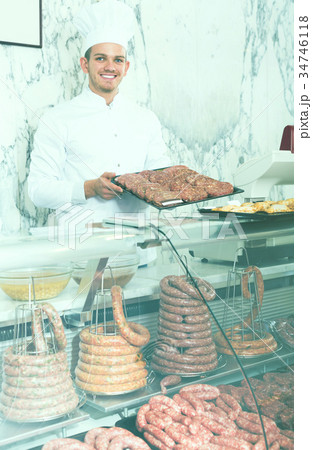 Young professional cook laying out food 34746118