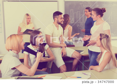 students chatting while sitting in the room 34747000