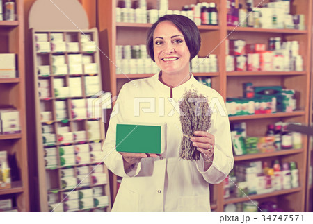 Portrait of happy female with dried plans 34747571