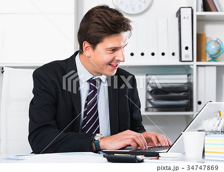 Businessman in office clothes filling up documents Businessman in office clothes filling up documents 34747869