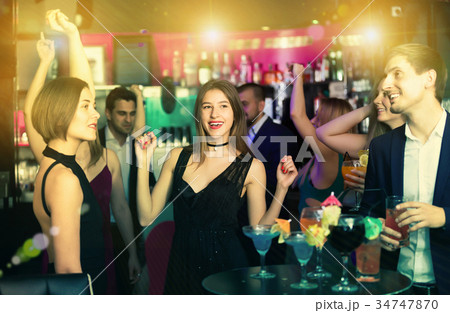 Friendly colleagues dancing on corporate party Friendly colleagues dancing on corporate party 34747870
