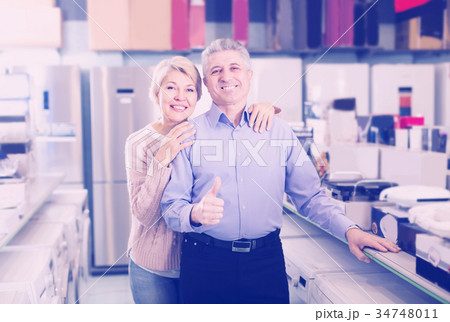 Adults are visiting shop of household appliances for buying goods Adults are visiting shop of household appliances for buying goods 34748011