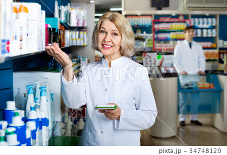 Portrait of two friendly glad smiling pharmacists working Portrait of two friendly glad smiling pharmacists working 34748120