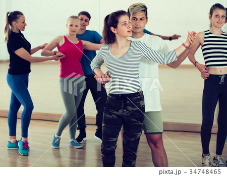 Group of smiling teenagers having dancing 34748465