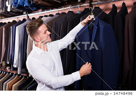 Man choosing new suit 34748496
