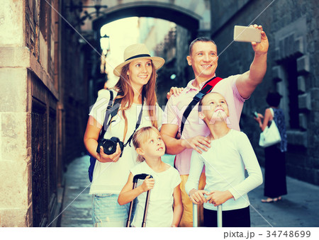 Travelers family taking selfie Travelers family taking selfie 34748699