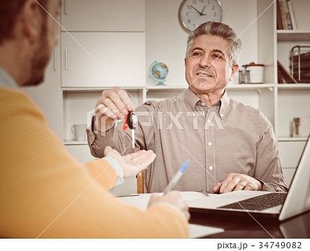 Mature man sign car purchase contract 34749082