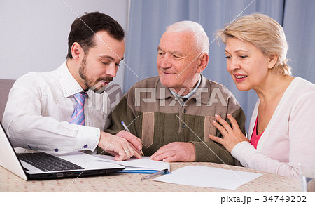 Woman and old man consider contract 34749202