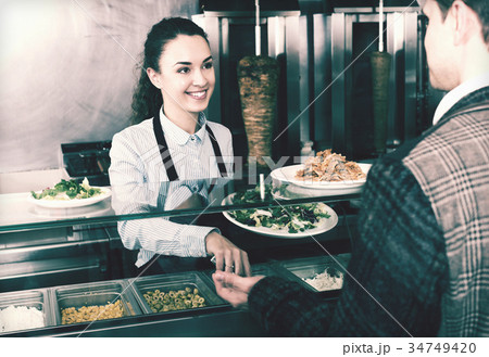 Girl and satisfied customer buying kebab Girl and satisfied customer buying kebab 34749420