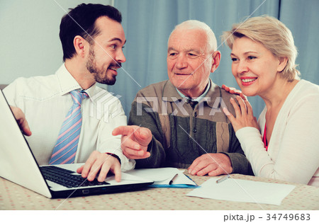 Woman and old man consider contract 34749683