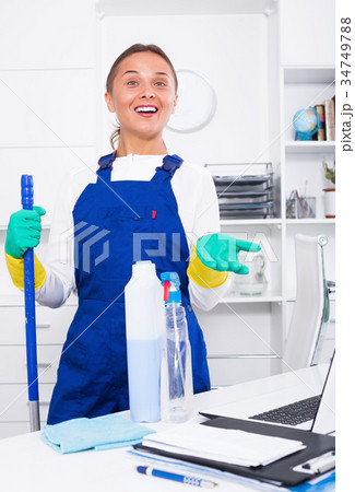 Female in protective uniform cleaning office 34749788