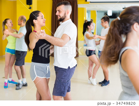 Positive people are dancing waltz in pairs 34749820