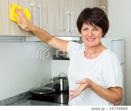 retiree woman cleaning home 34749866