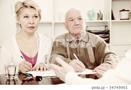 couple signing papers in bank couple signing papers in bank 34749901