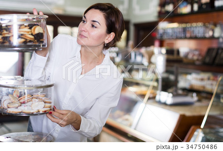 Woman choosing dessert Woman choosing dessert 34750486
