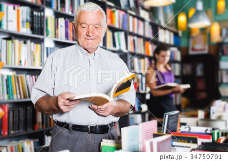 Mature man is choosing book Mature man is choosing book 34750701